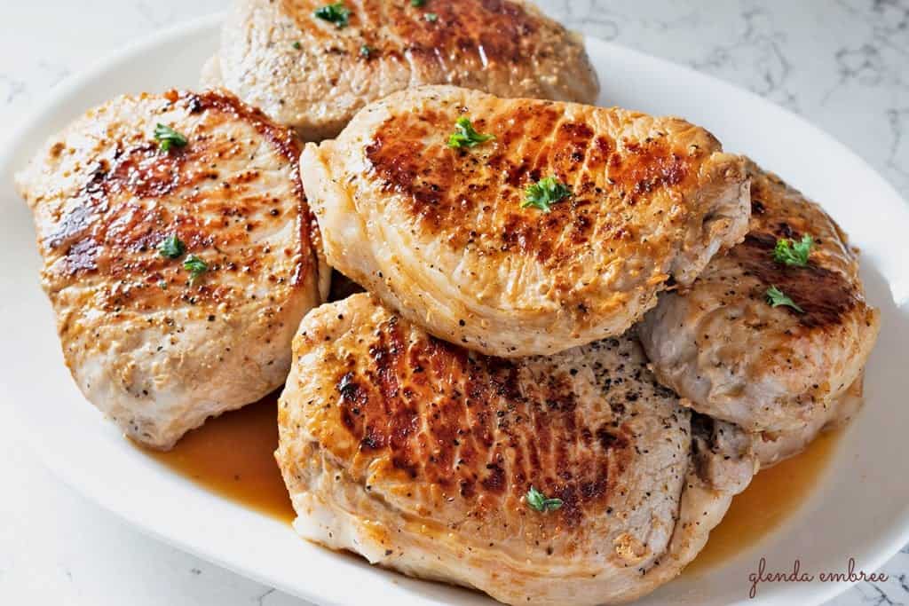 Perfect Pan Seared Pork Chops on a white serving platter