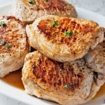 Perfect Pan Seared Pork Chops on a white serving platter