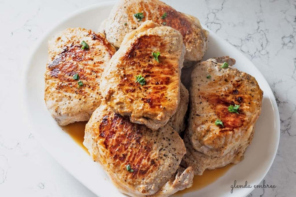 Perfect Pan Seared Pork Chops on a white serving platter