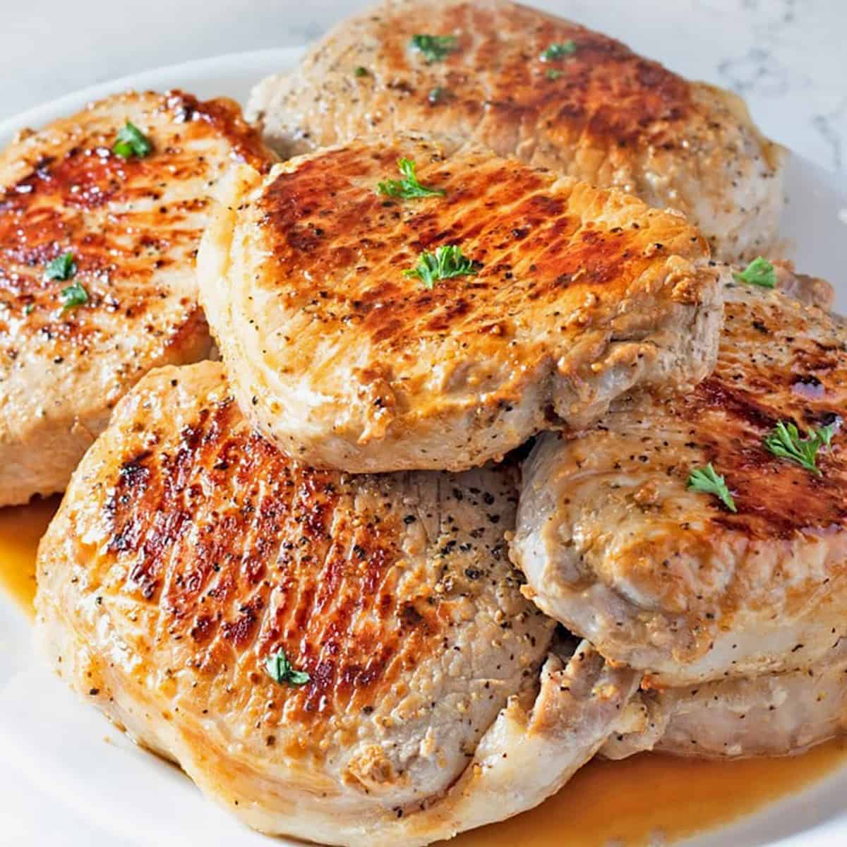 Perfect Pan Seared Pork Chops on a white serving platter