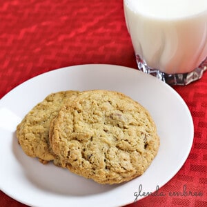 oatmeal cookies on a white plate sitting on a red tablecloth