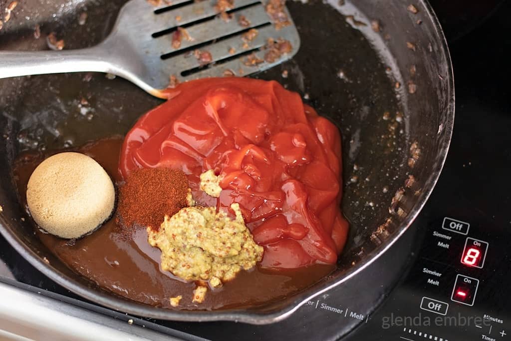 sloppy joe sauce ingredients in a cast iron skillet