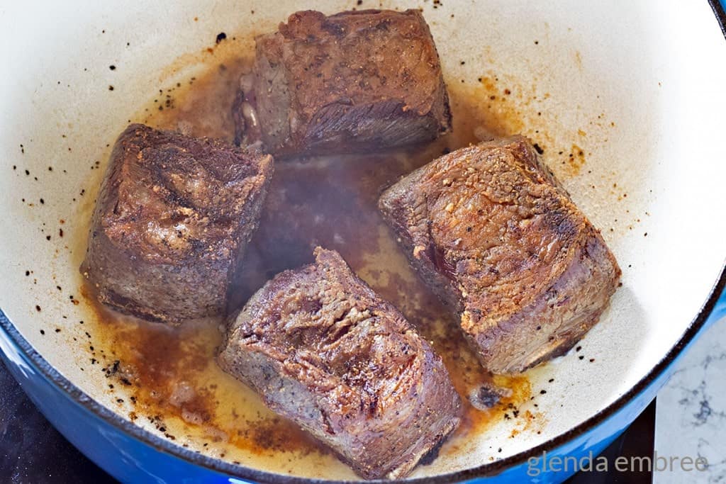 Beef Short Ribs searing in a Dutch oven