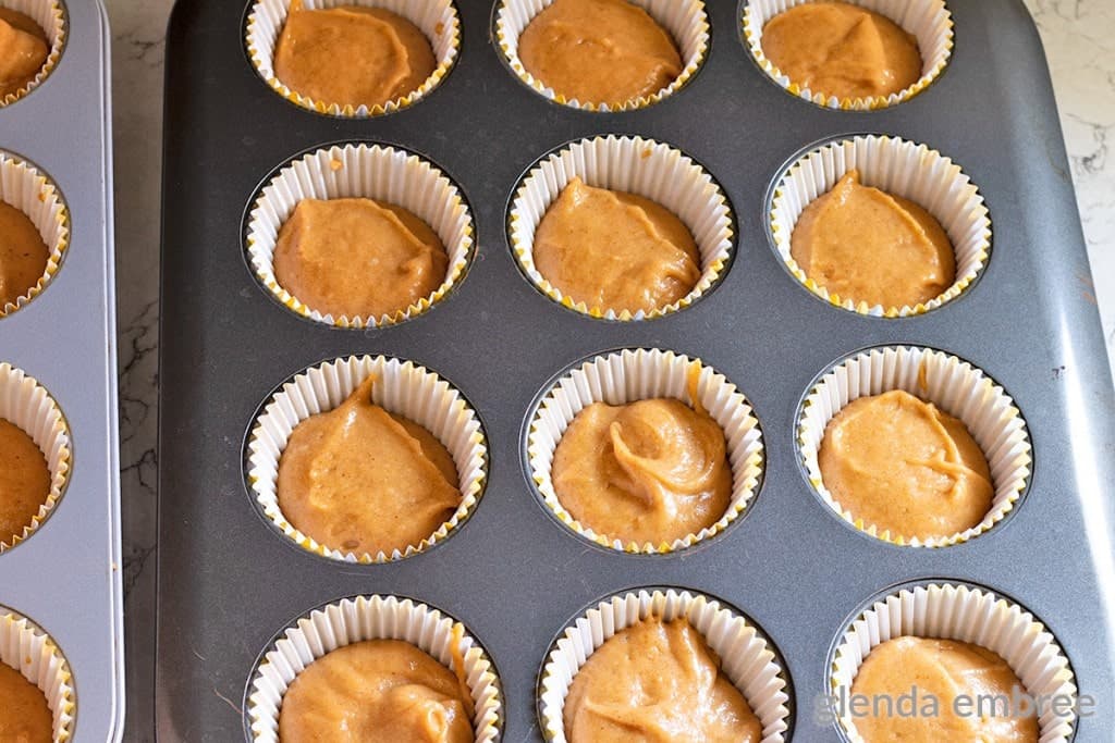 muffin tins filled with gluten free pumpkin batter