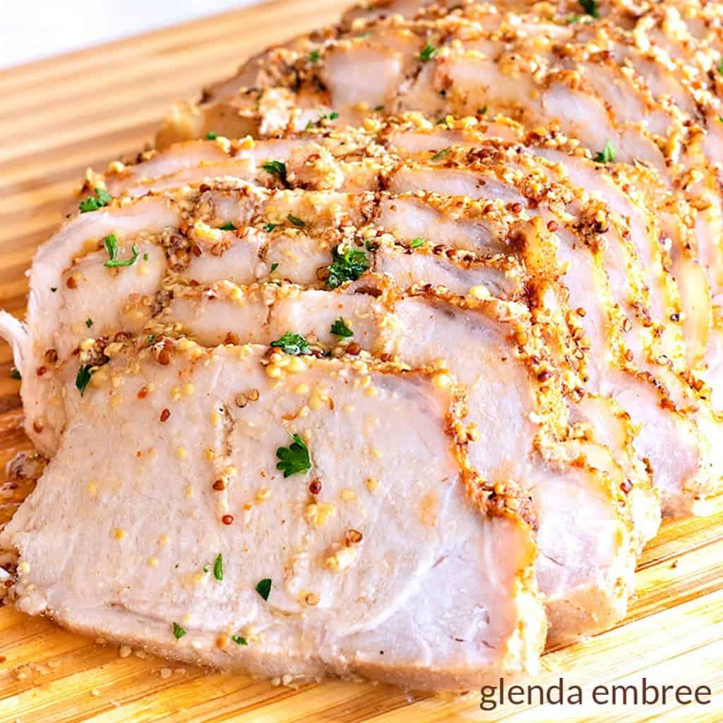 Maple Mustard Pork Loin sliced on a wooden cutting board - easy recipes - family recipes