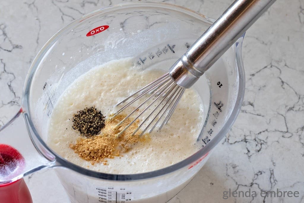 seasonings added to milk mixture in measuring cup