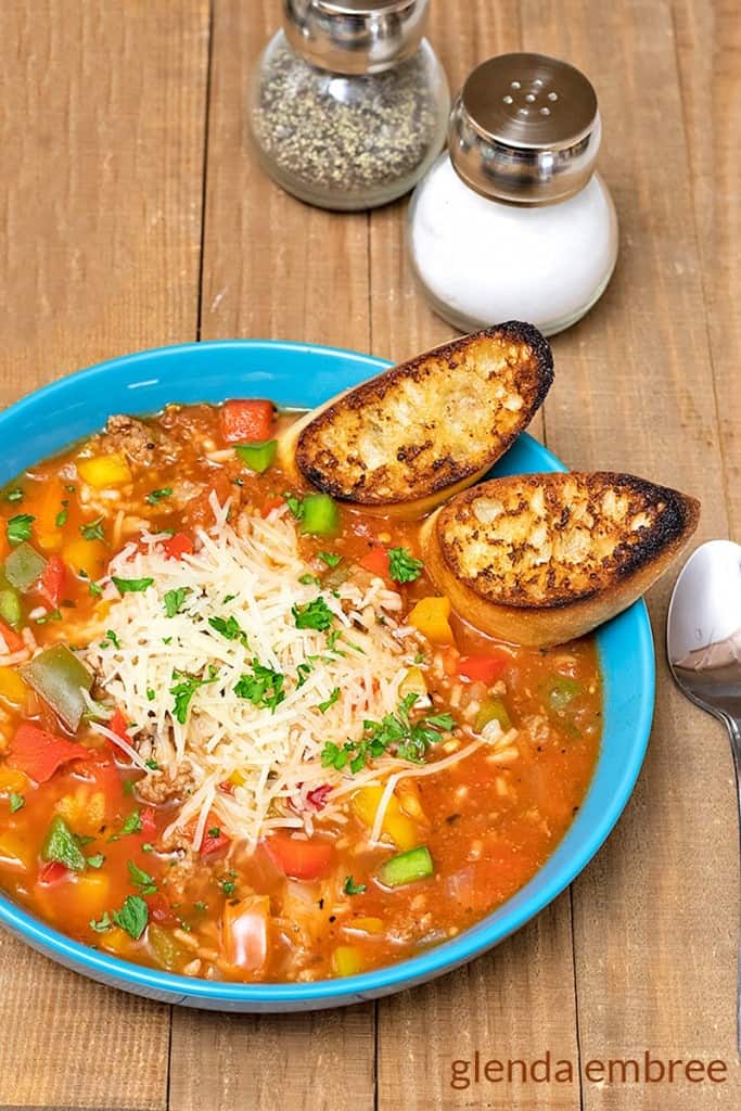 Stuffed Pepper Soup in a blue bowl with toasted crostini