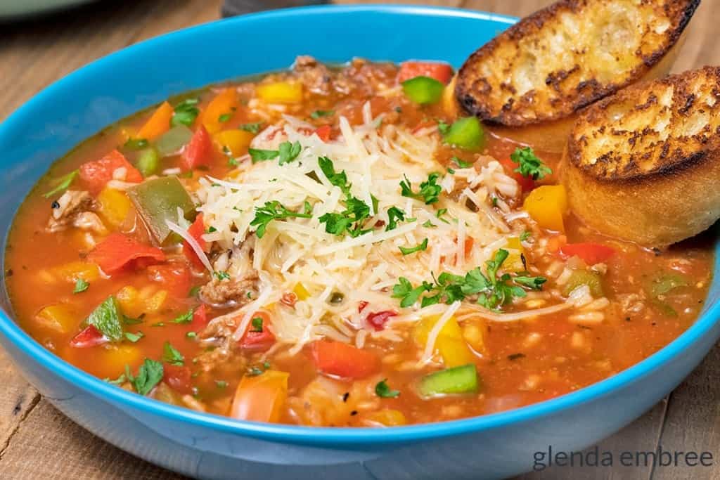 Stuffed Pepper Soup in a blue bowl with toasted crostini