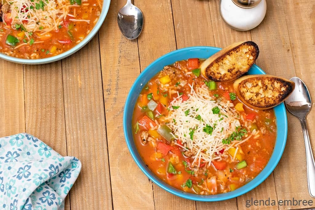 Stuffed Pepper Soup in a blue bowl with toasted crostini