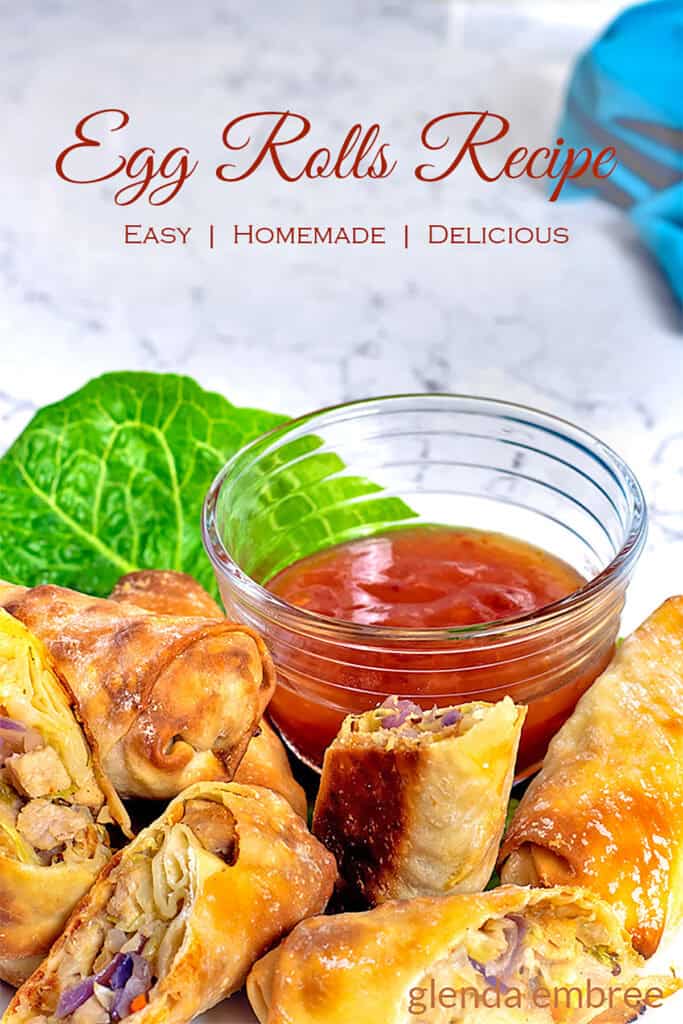 Egg Rolls on a white platter with sweet chili dipping sauce.