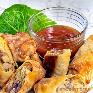 Homemade Egg Rolls on a white plate served with Sweet Chili Sauce