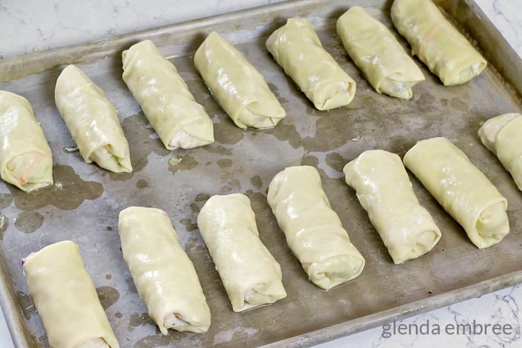 rolled egg rolls on cookie sheet