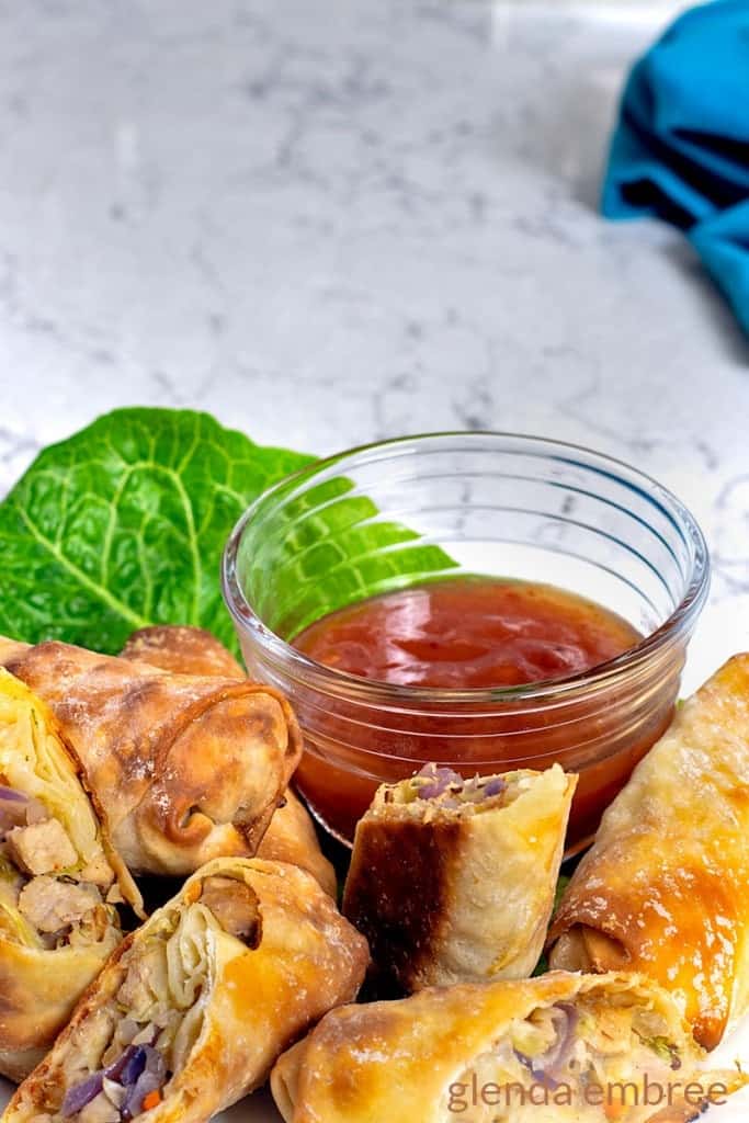 Homemade Egg Rolls on a white plate served with Sweet Chili Sauce