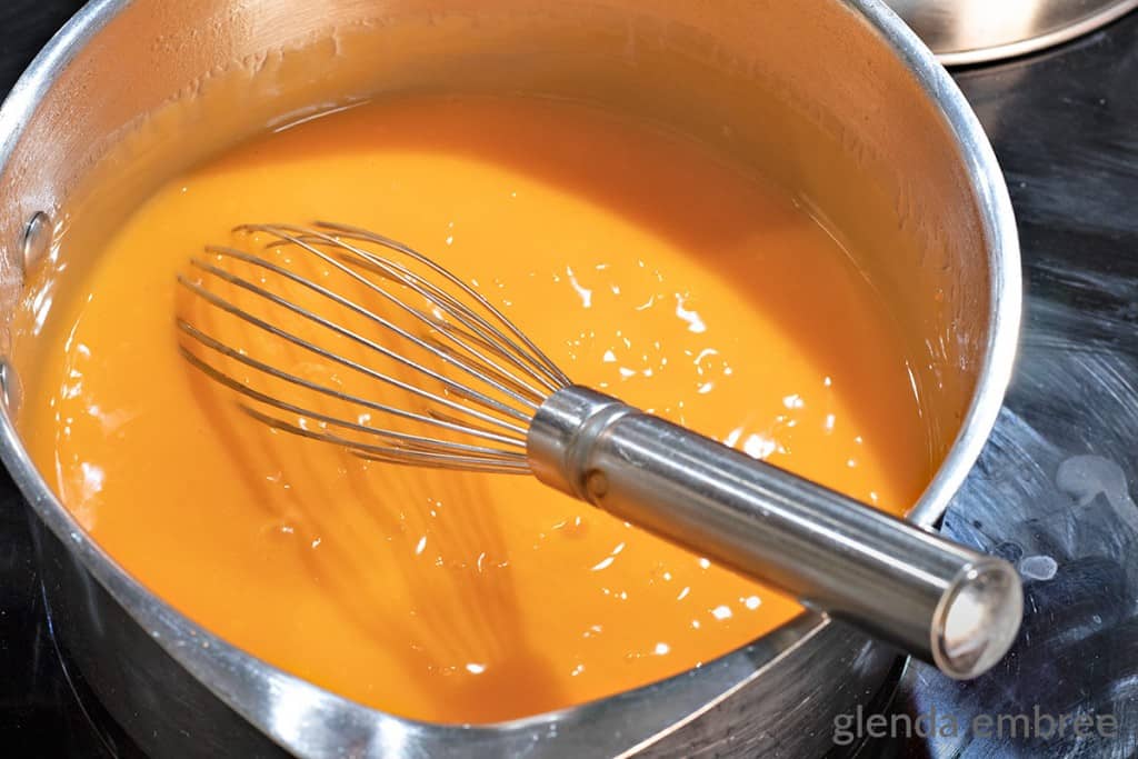 boiling and thickened mandarin orange salad ingredients in a sauce pan