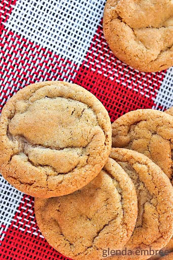 Soft Ginger Cookies on red and white checked cloth, next to a train Christmas ornament