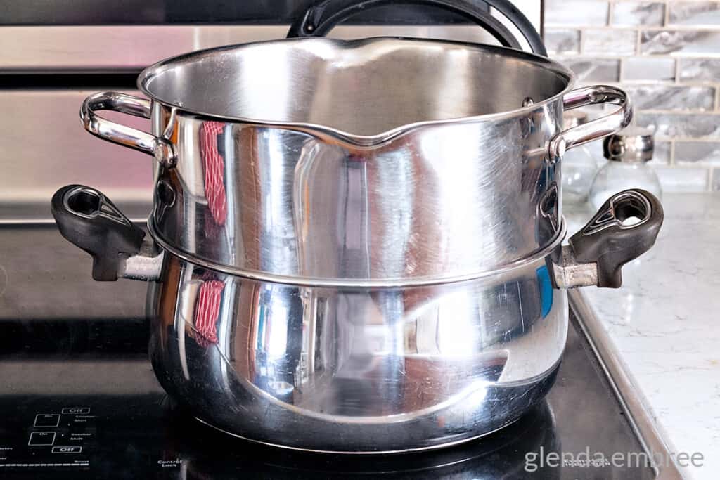 Using two pans to make a DIY double boiler.