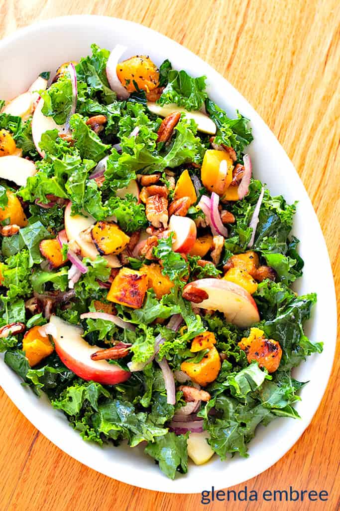 Kale Apple and Butternut Salad in a white serving bowl