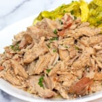 kalua pork with braised cabbage on a white platter