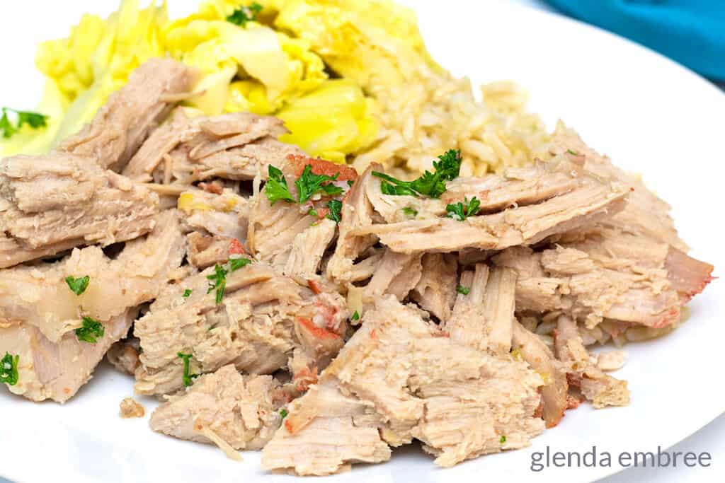 Kalua Pork on a white plate with cabbage and rice.  Easy pork loin recipe.
