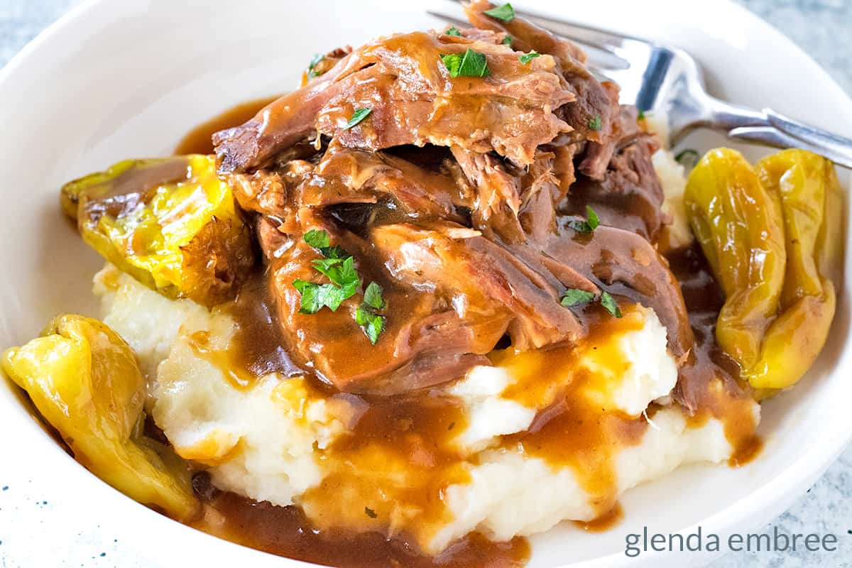 Mississippi Pot Roast served over mashed potatoes with beef gravy