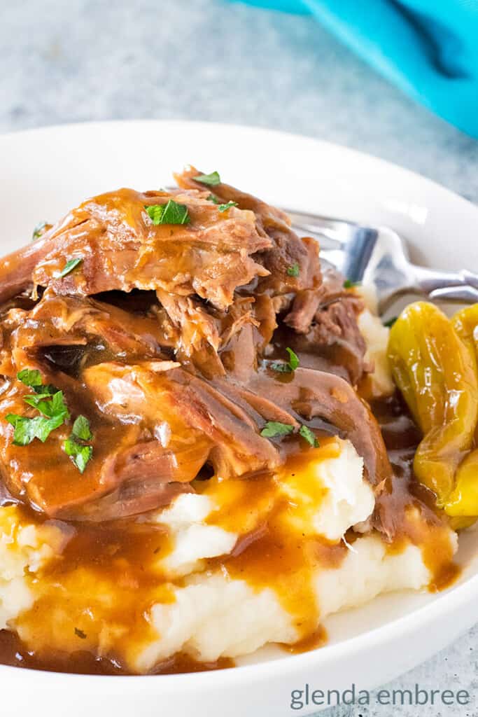 Mississippi Pot Roast served over mashed potatoes with beef gravy