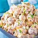 loaded baked potato salad in a gray rectangular pottery bowl