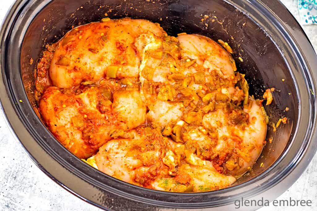 southwest chicken ingredients combined and ready to cook inside a slow cooker