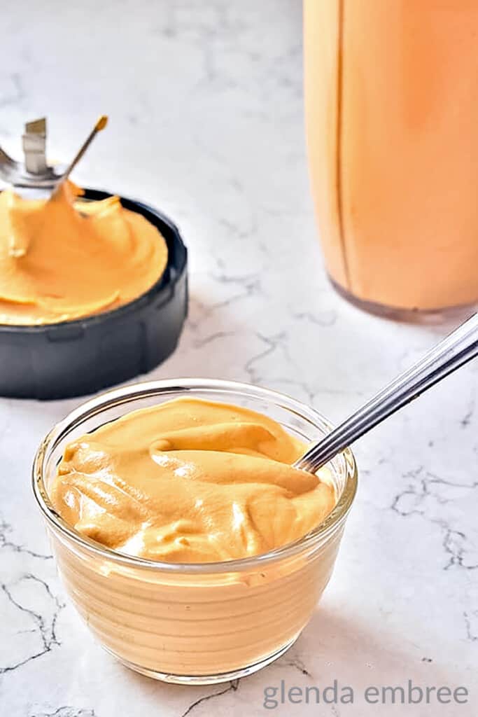 cashew queso in a clear glass bowl