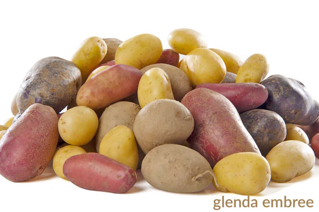 pile of several potato varieties on a white counter