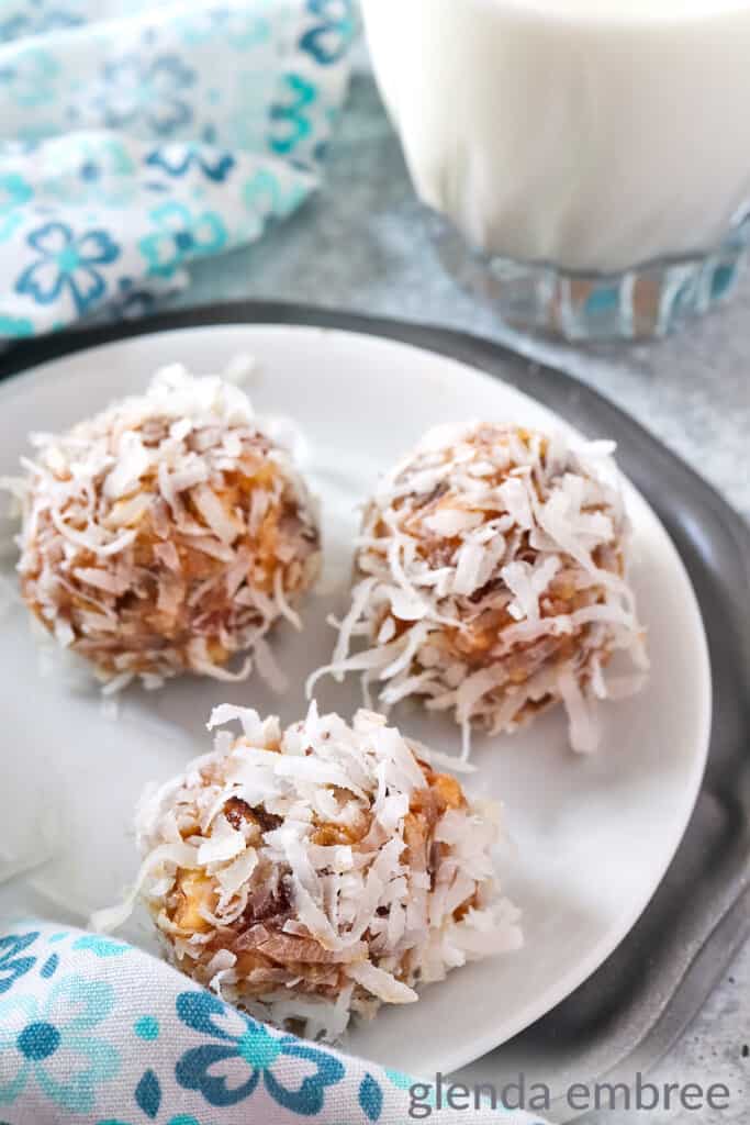 date balls on a white plate sitting on a pewter charger