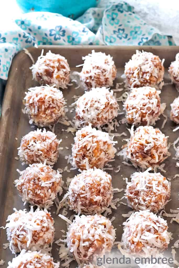 finished date balls on a baking sheet ready to be frozen or chilled
