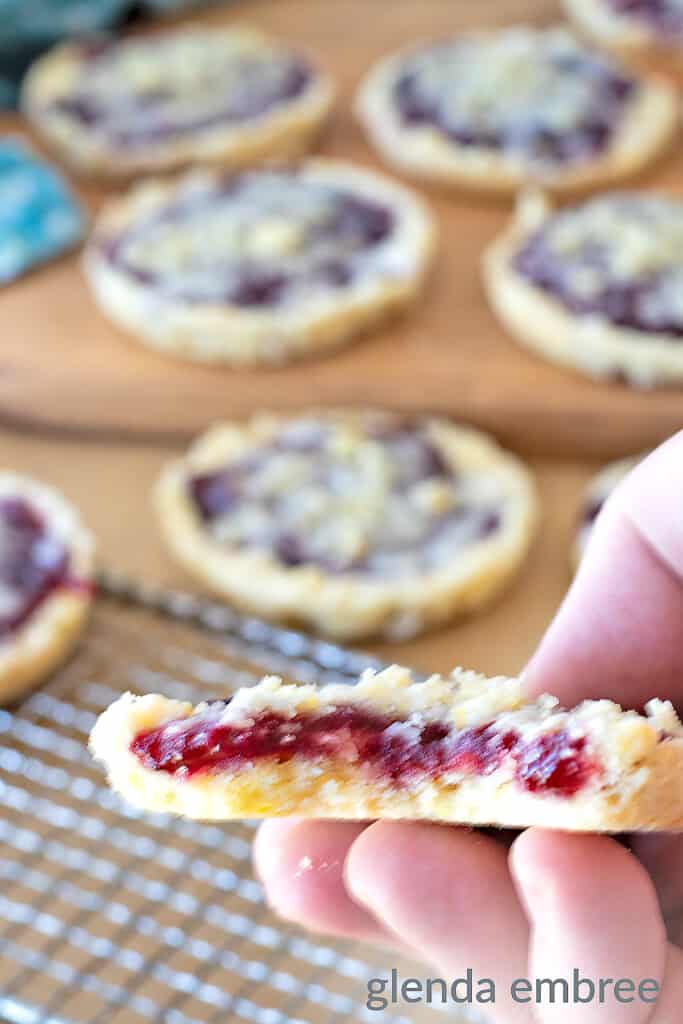 copycat costco raspberry crumble cookie with bite taken out exposing the jammy center
