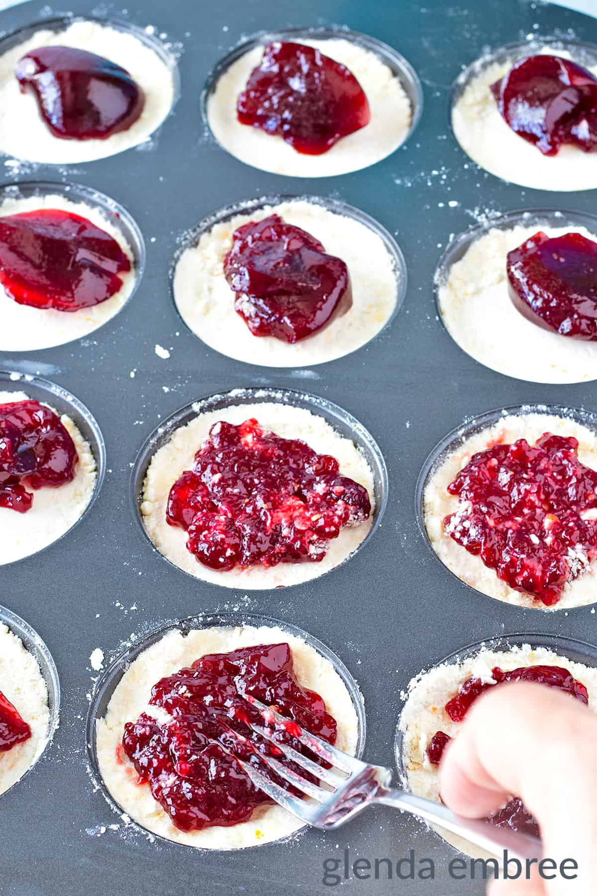 copycat costco raspberry crumble cookies baked with jam layer being spread with a fork