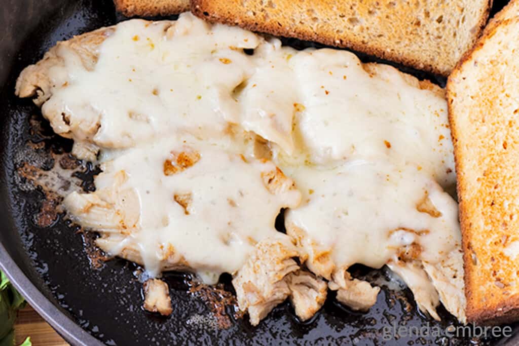 leftover turkey warmed in a cast iron skillet with Monterey Jack cheese melted on top