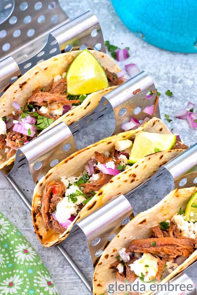 finished Mexican Street tacos in a taco rack - shredded beef tacos