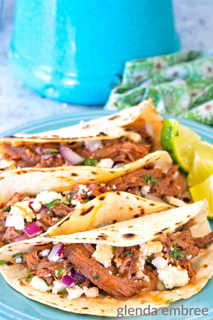 Mexican Street Tacos on a blue stoneware plate - shredded beef tacos