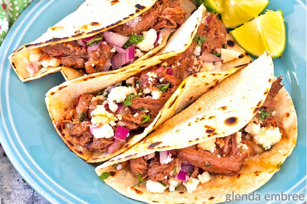 Mexican Street Tacos on a blue stoneware plate - shredded beef tacos