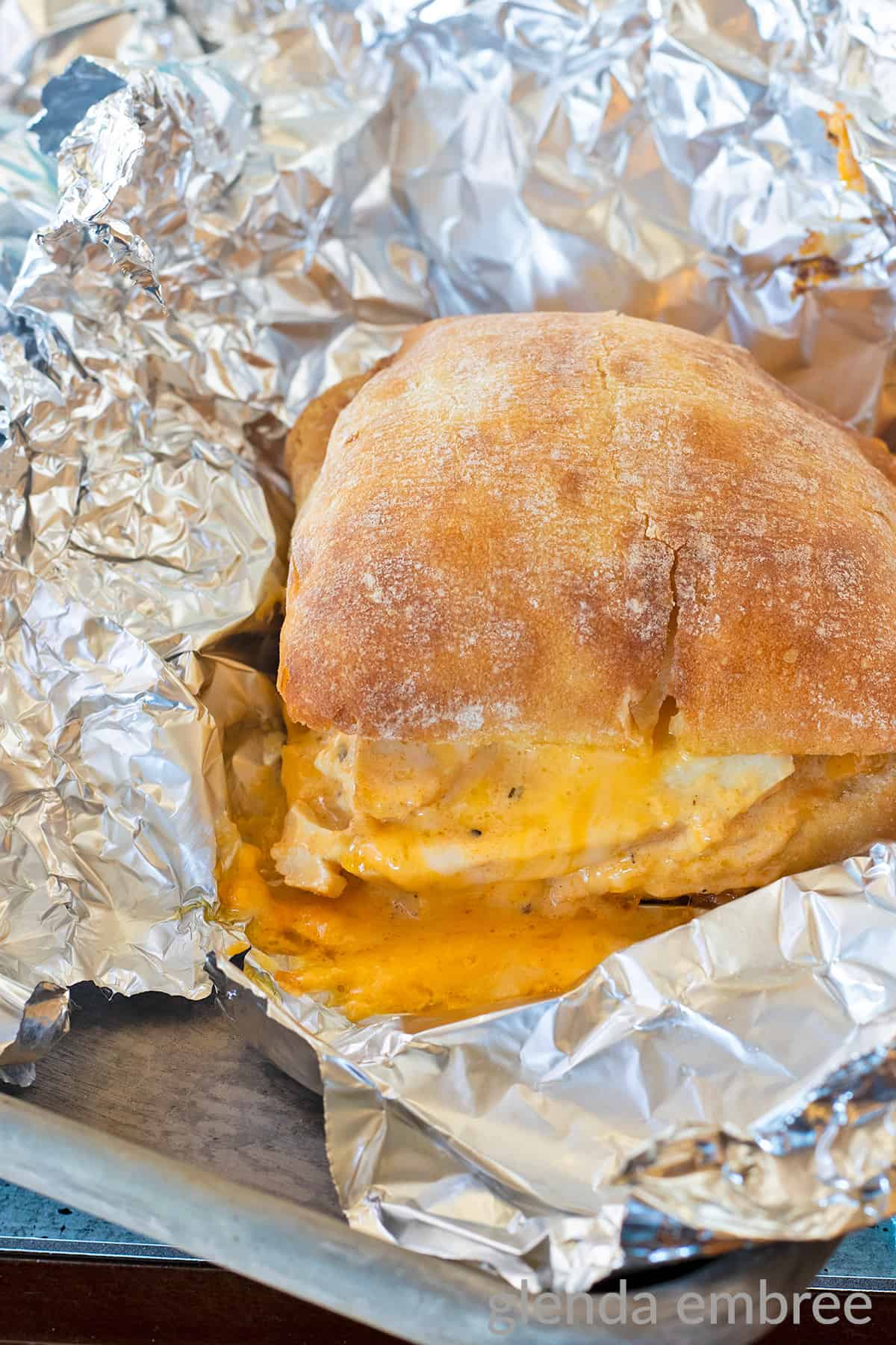 Buffalo Ranch Chicken Melt with melty cheese being unwrapped from foil after baking
