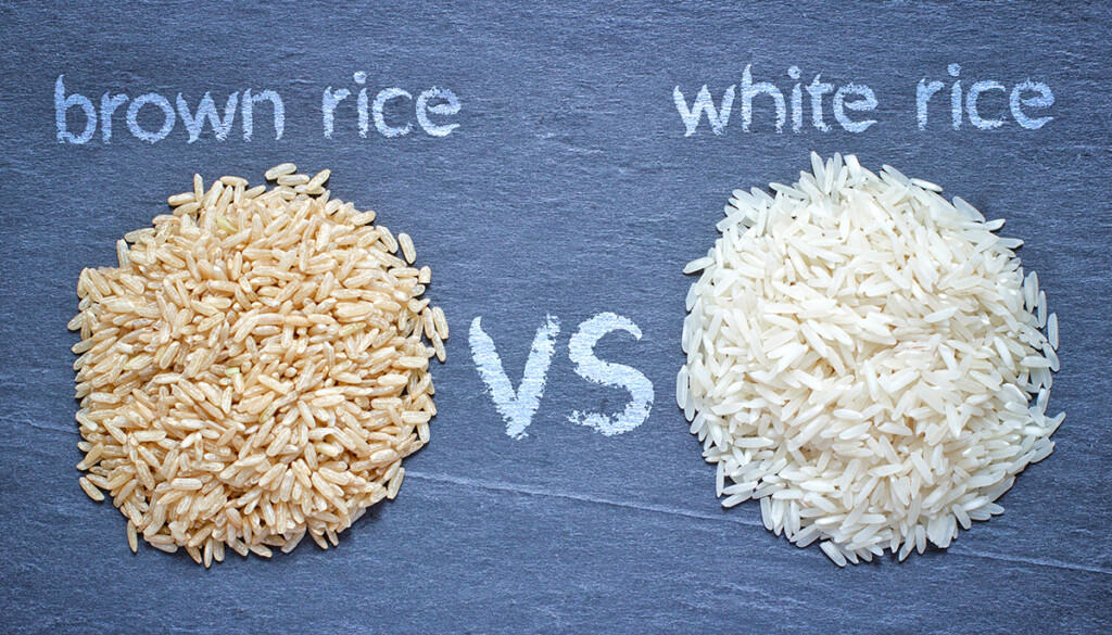 Brown Rice and White Rice in two piles on a chalkboard.  Brown Rice vs White Rice is written in chalk.