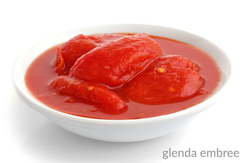 whole peeled tomatoes in juice in a white bowl