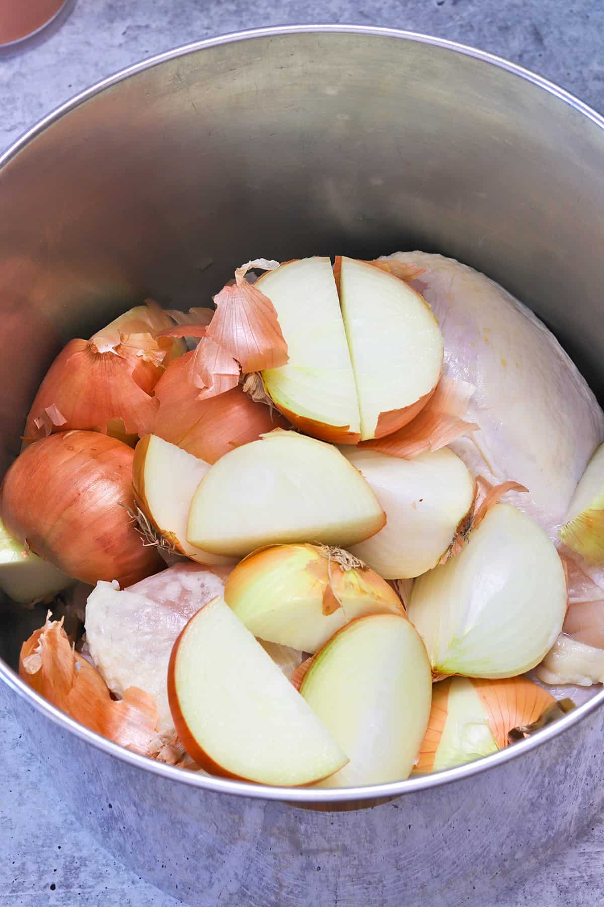 Making Chicken Stock - add quartered onions to pot with chicken pieces