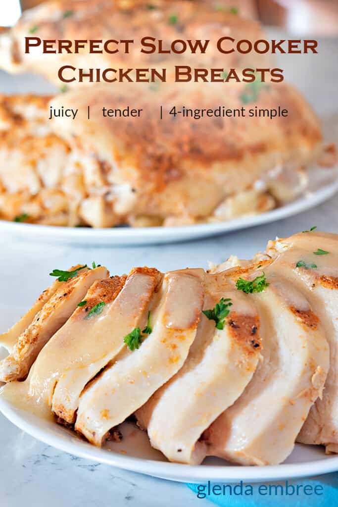 Slow Cooker Chicken Breasts sliced on a plate with a platter of slow cooker chicken breasts in the background