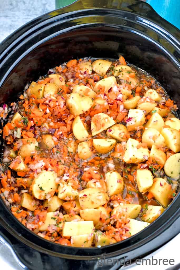 Crock-Pot Potato Soup ingredients mixed together in a slow cooker, ready to be cooked.