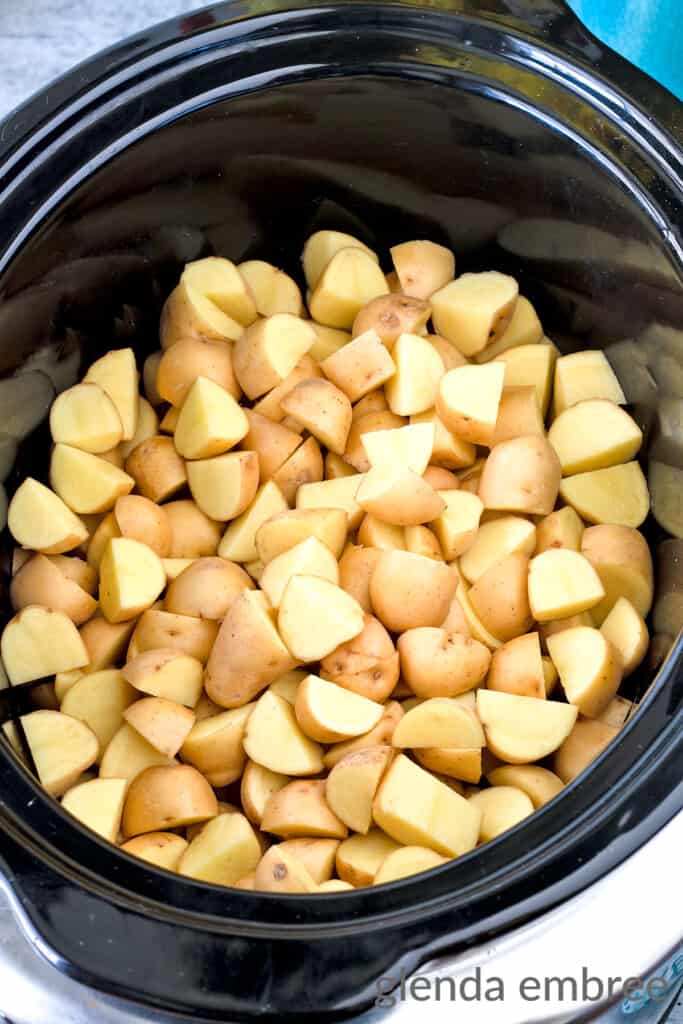 Baby Golden Potatoes in a black crock pot liner.