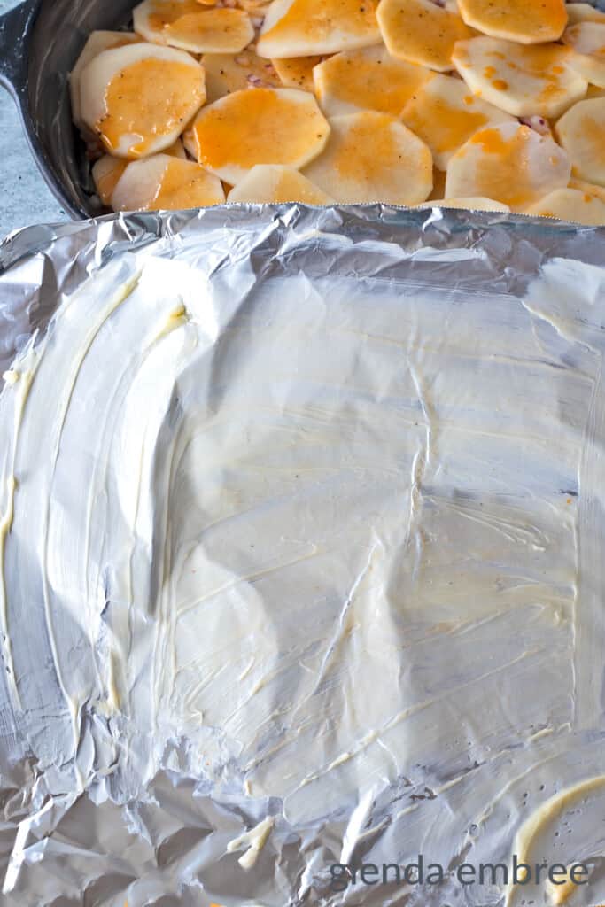 Grease a sheet of foil with reserved butter