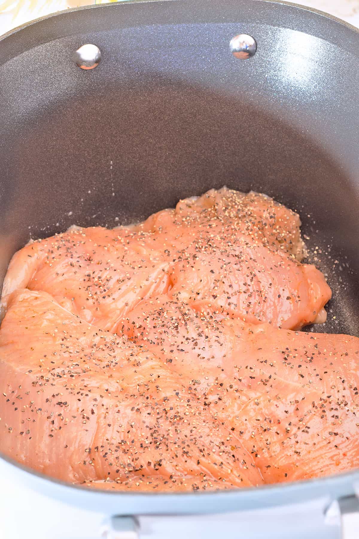 salted and peppered tureky tenderloins in a crockpot