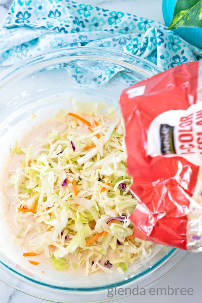 Adding cabbage slaw mix to coleslaw dressing
