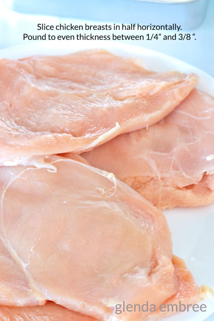 Boneless Skinless Chicken breasts, sliced horizontally and pounded thin. Chicken breasts are sitting on a white plate