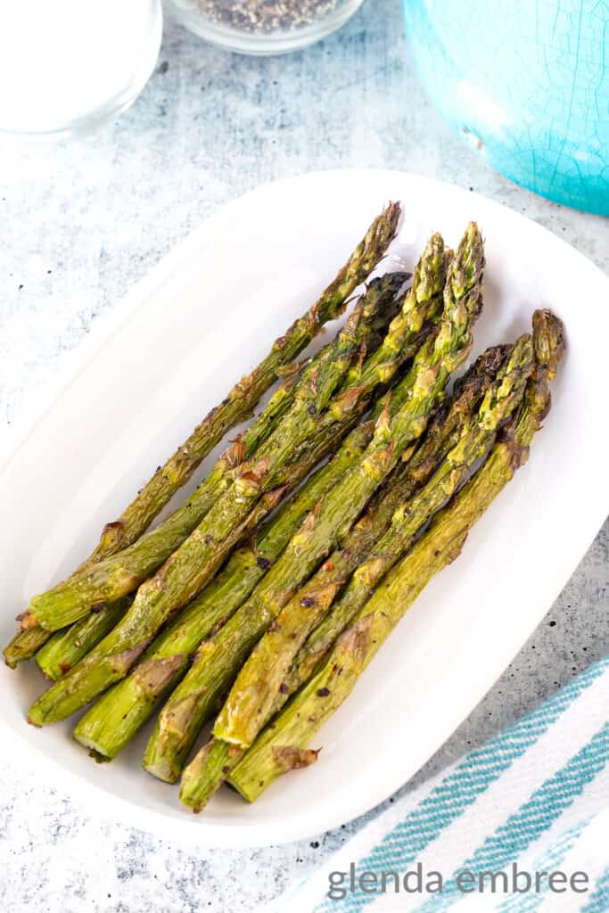 Air Fryer Asparagus recipe in a white oval serving dish.