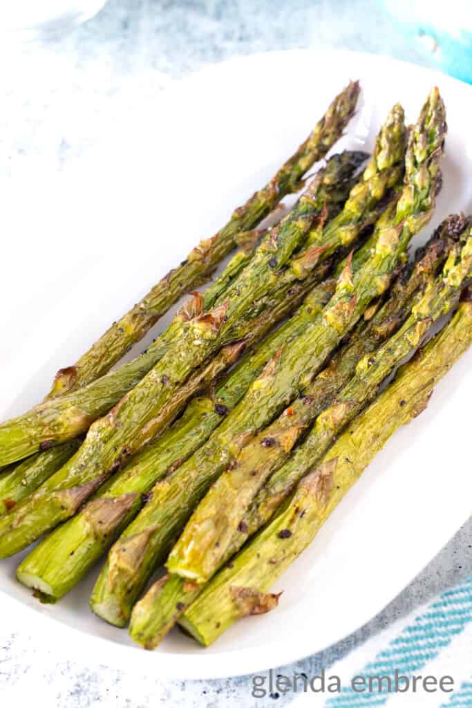 Air Fryer Asparagus in a white oval serving dish.